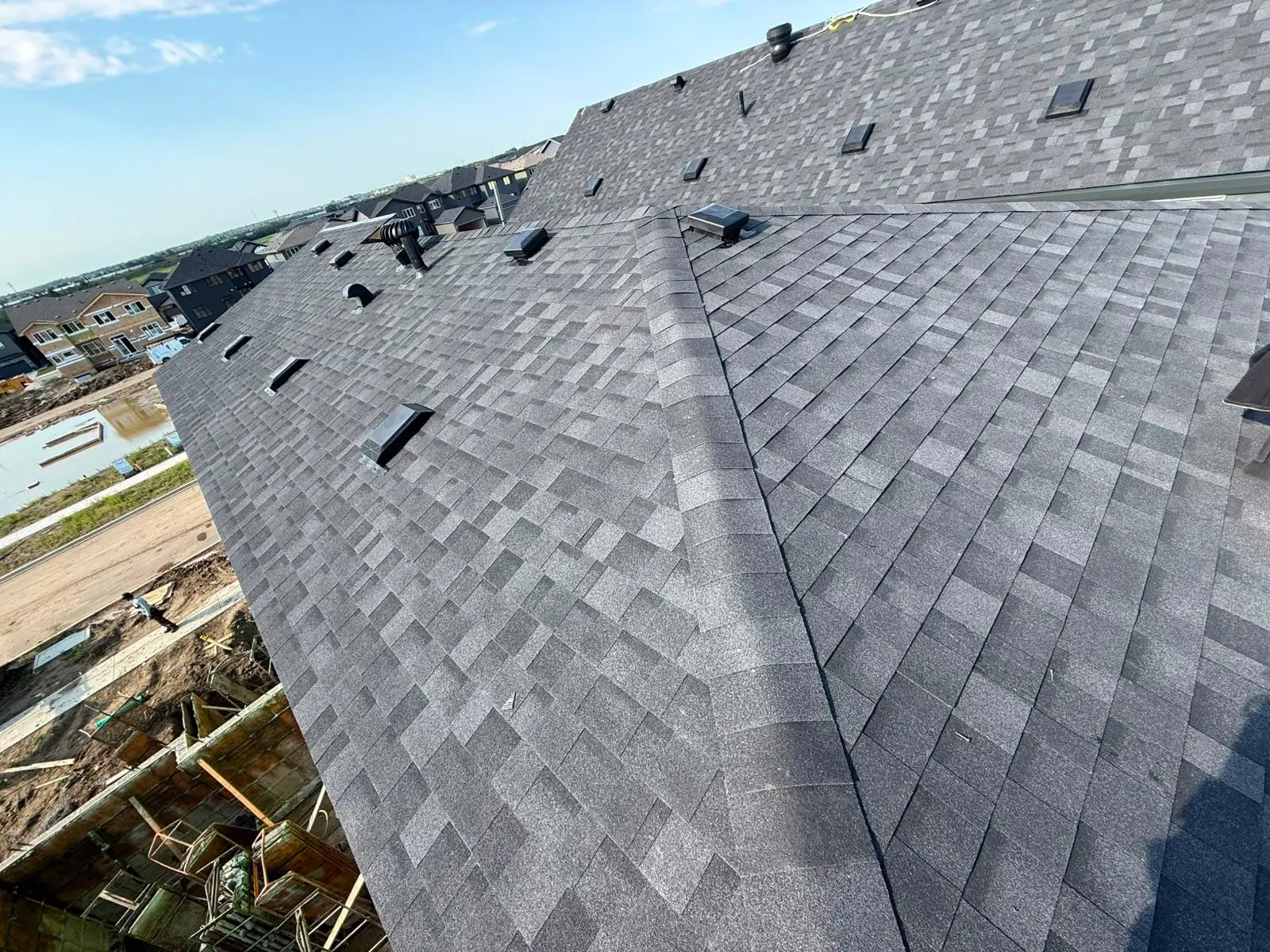 Completed architectural shingle roof on a large new build home