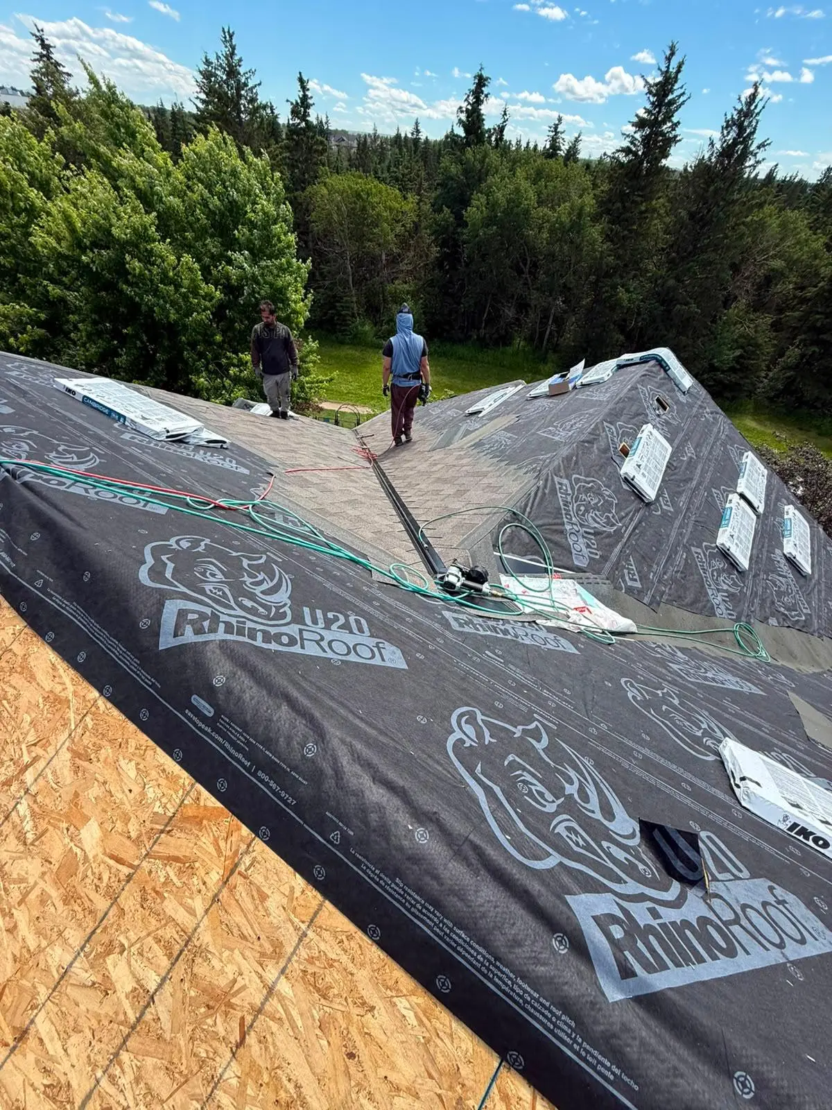 Ariram Roofing crew installing underlayment on a roof