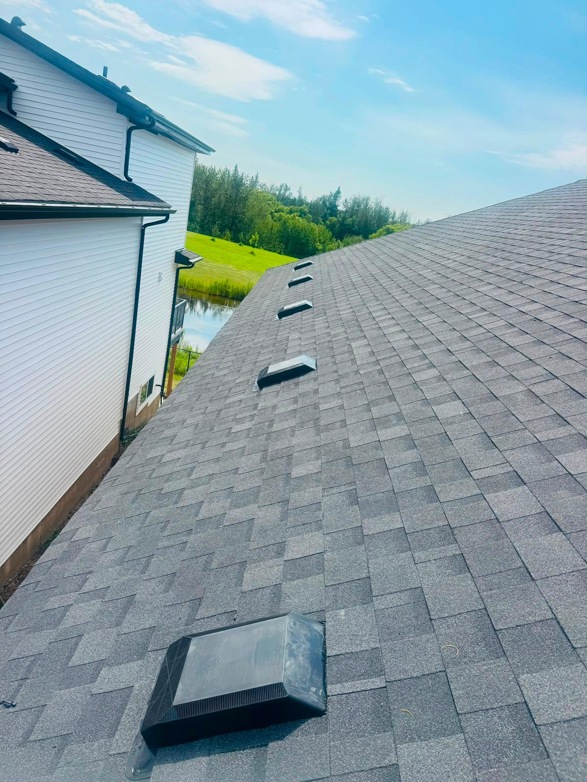 Fresh shingle roof slope with new roof vents installed